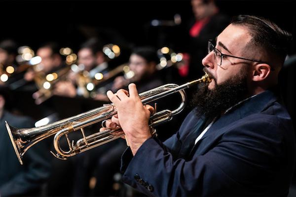 male student playing the trumpet